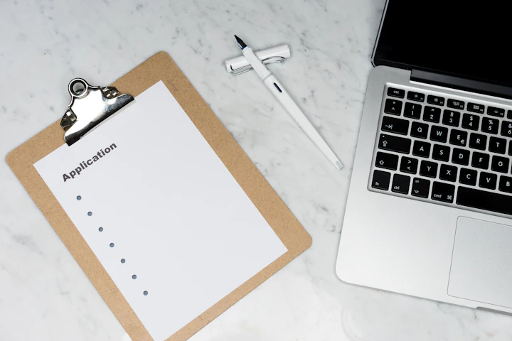 Clipboard checklist next to a laptop