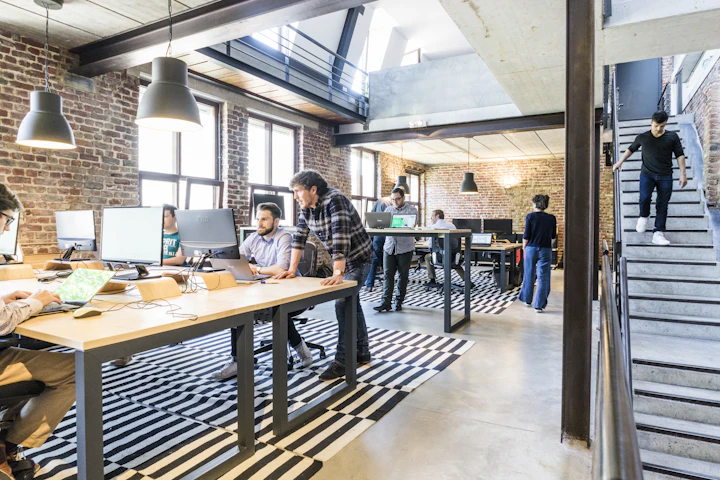 Open-plan startup office with exposed brick