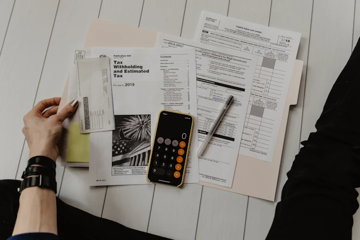 Tax forms and a calculator on a desk